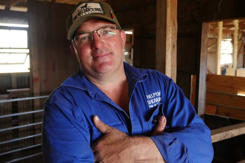 Hilton Barrett stands in a shearing shed.