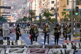 Picture of a security forces standing guard in the middle of a street