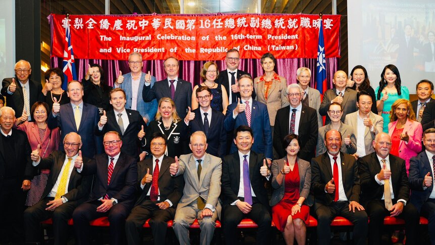 australian mps hold their thumbs up at an event celebrating the inauguration of Taiwan's new president