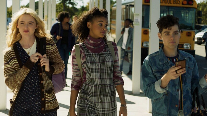 A scene from the movie Freaky with Kathryn Newton, Celeste O'Connor & Misha Osherovich, high school students walking into school