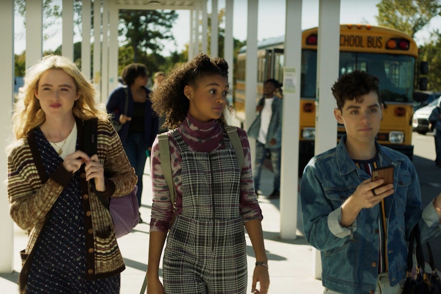 A scene from the movie Freaky with Kathryn Newton, Celeste O'Connor & Misha Osherovich, high school students walking into school