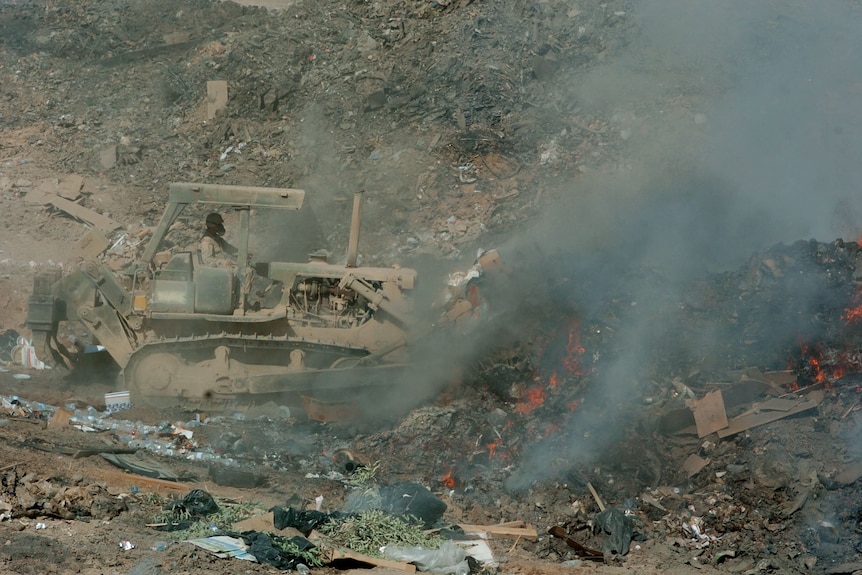 Bulldozer in a burn pit.