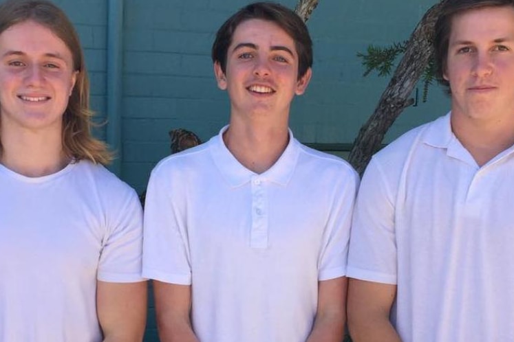 three teenagers stand together. One of them is Eden Buckingham, who died by suicide