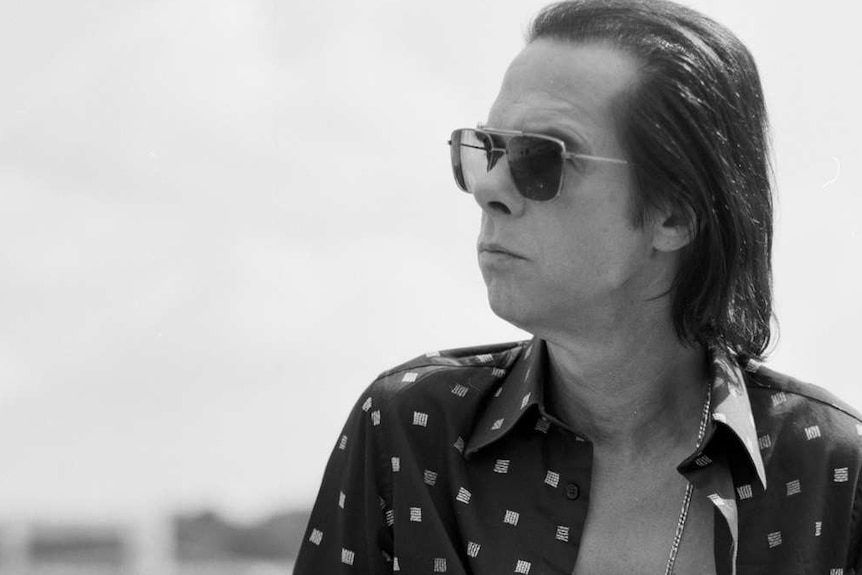 black and white picture of Nick Cave wearing sunglasses