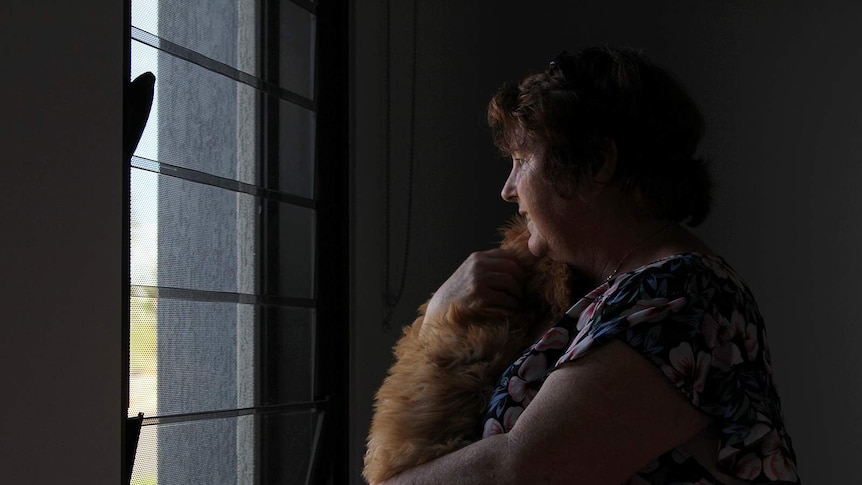 Mitchell Creek Green Resident looking out the window in her front room.