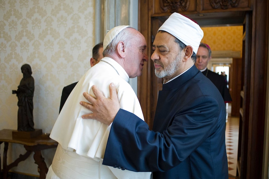Pope Francis and Ahmed al-Tayeb greet each other.
