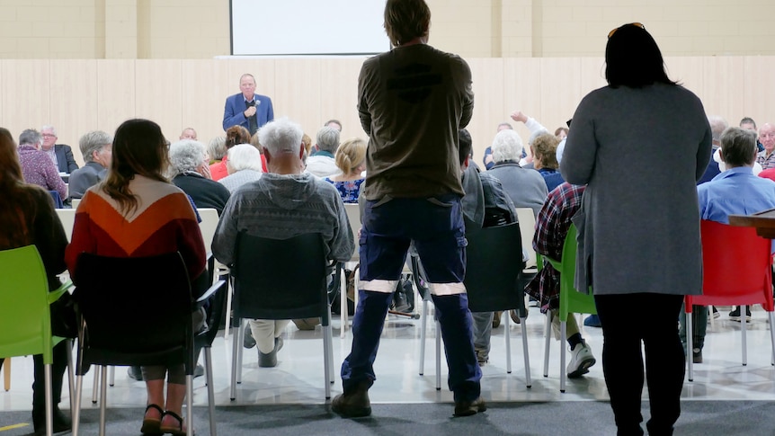 The view of a public meeting from the back.