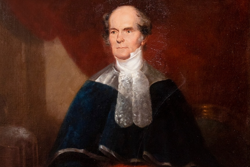 An 1800s painting of a balding, middle-aged man in formal attire