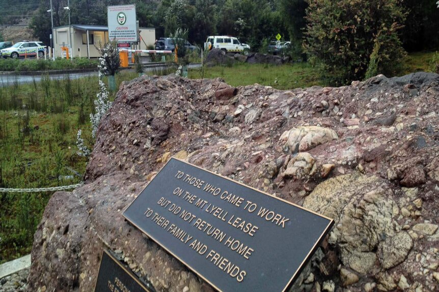 A plaque honouring miners who have died at work sits outside the gates of the Mount Lyell copper mine, at Queenstown.