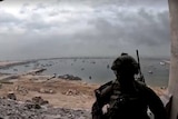 a soldier looks out at the port of gaza allegedly