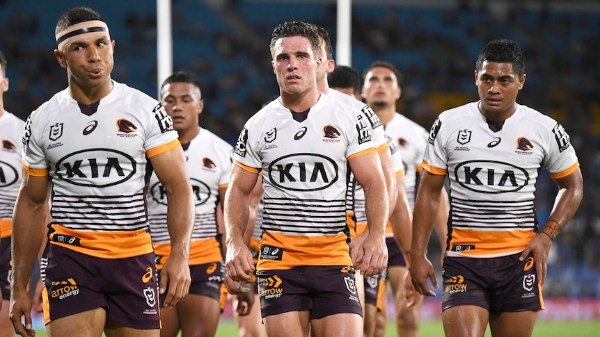 David Mead, Brodie Croft, Anthony Milford lead the Brisbane Broncos on the field during an NRL game.