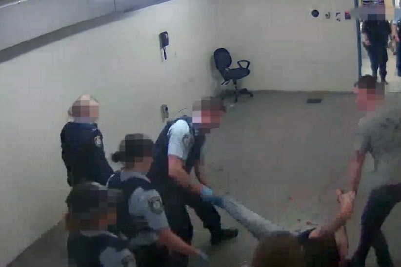 CCTV vision shows a woman being dragged by police officers.