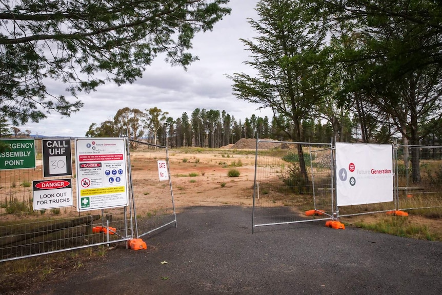 a construction gate with vacant land where accommodation is planned