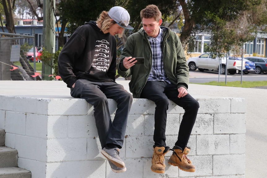Harley Newman (left) and Tyler Birch (right) review a video.