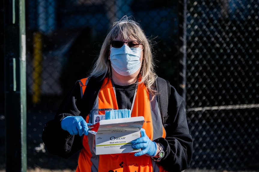 Woman handing out masks