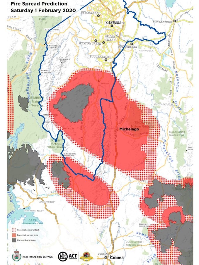 Fire spread prediction maps show the fire could potentially burn through areas like Michelago and Tharwa.