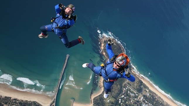 Michael Vaughan (left) and Jules McConnel jump from a plane above Moruya Heads