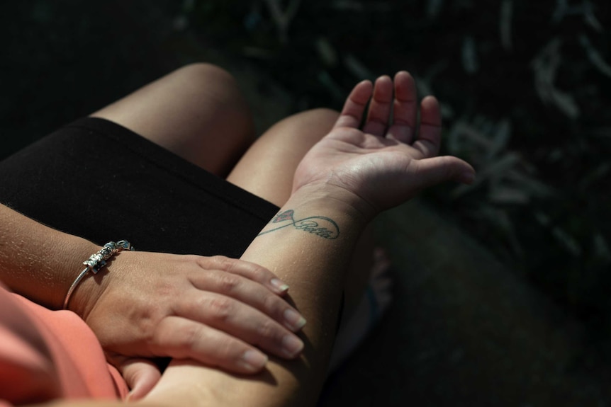 A close up shot of a woman's wrist tattoo which reads 'Bella'