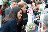 Britain’s Prince Harry and his fiancee Meghan Markle greet the public at an event