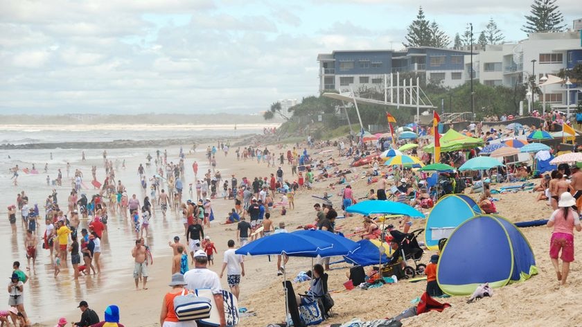 Crowds flock to Kings Beach at Caloundra.