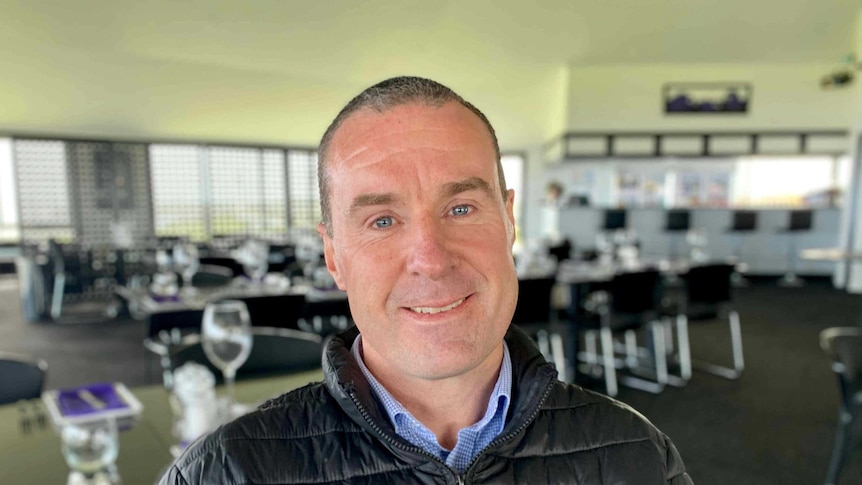 A man poses for a photo inside a restaurant