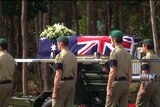 Soldiers follow the coffin procession at a funeral for Private Ben Chuck at Lake Tinaroo.