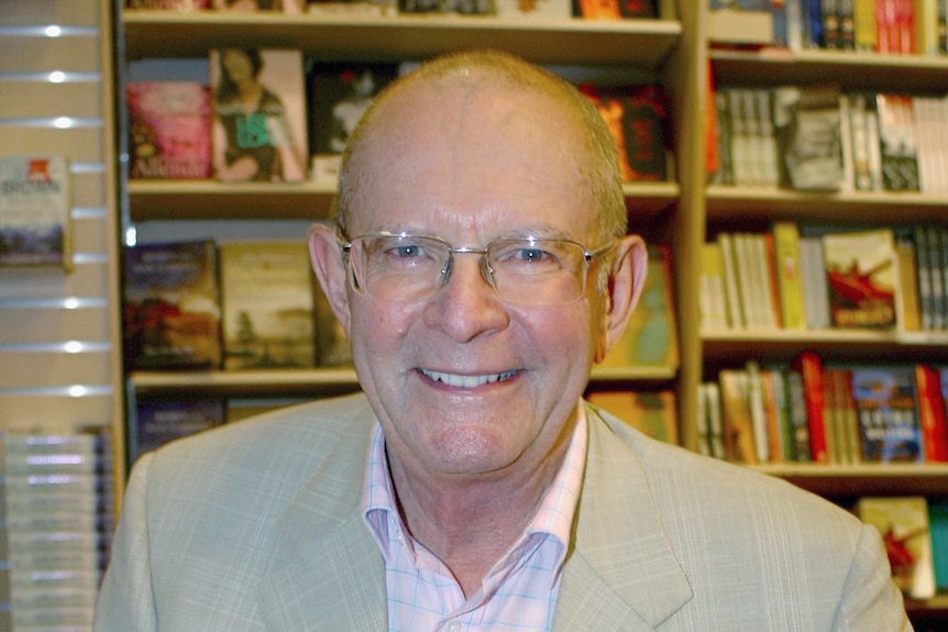 Author Wilbur Smith smiles as he poses during a book signing in Sydney, Australia