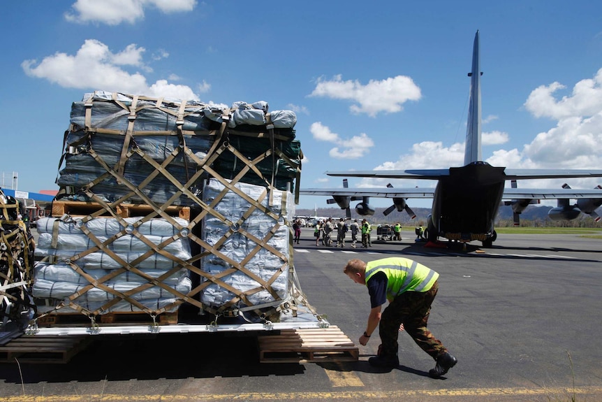 Military personnel unloads relief supplies in Port Vila