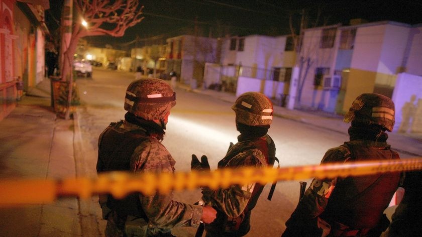 Soldiers guard a crime scene in Ciudad Juarez