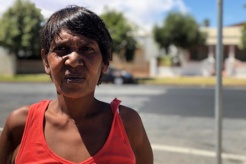 A portrait of Indigenous woman Julie Bugmy, with Argent Street in soft focus behind her.