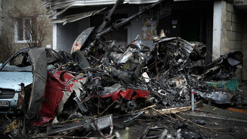 A heap of wrecked metal with helicopter propellers visible