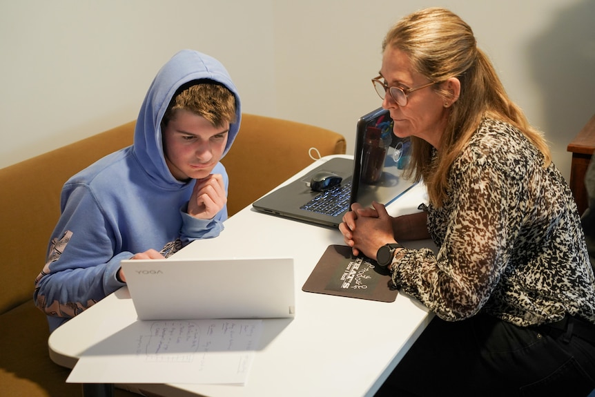 Emily Pearce and her son Sam doing school work.