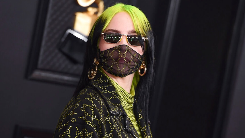 Billie Eilish arrives at the grammy awards wearing sunglasses and a face mask