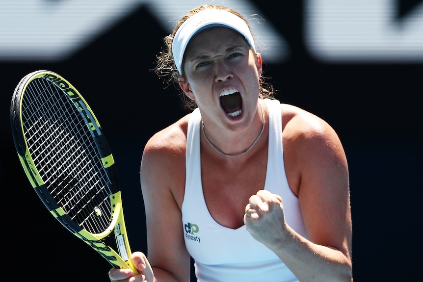 An American female tennis player screams out as she celebrates winning a point.