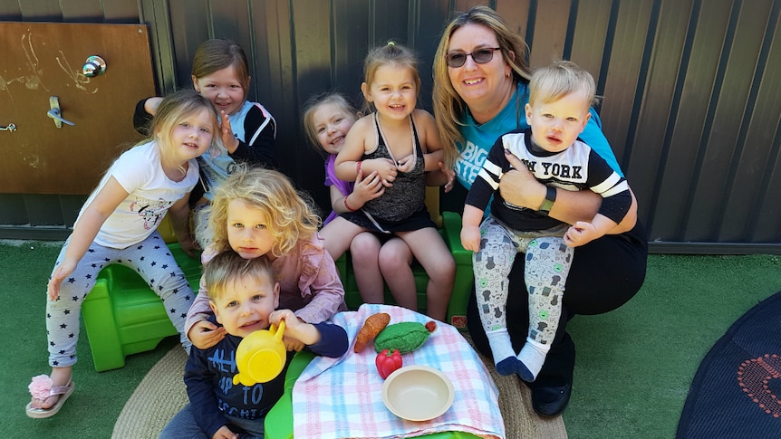 Childcare centre director Tracey Bell with some children.