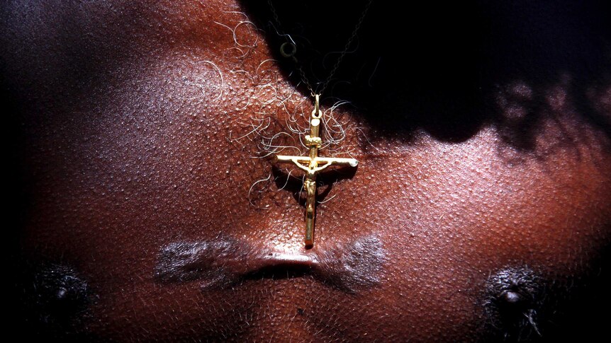 Bruce Gaykamangu wears a crucifix