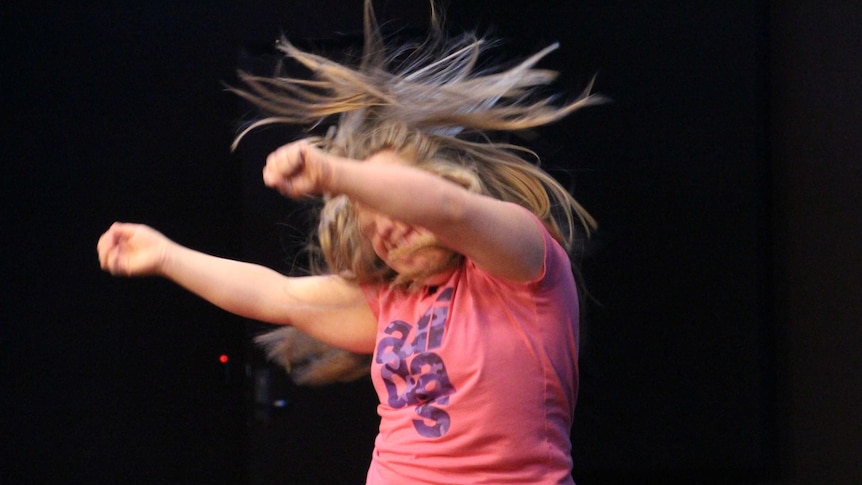 Lauren Marchbank throws her arms and hair around dancing her Hip Hop solo to her favourite singer Pink.
