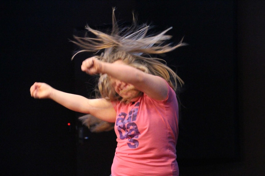 Lauren Marchbank throws her arms and hair around dancing her Hip Hop solo to her favourite singer Pink.