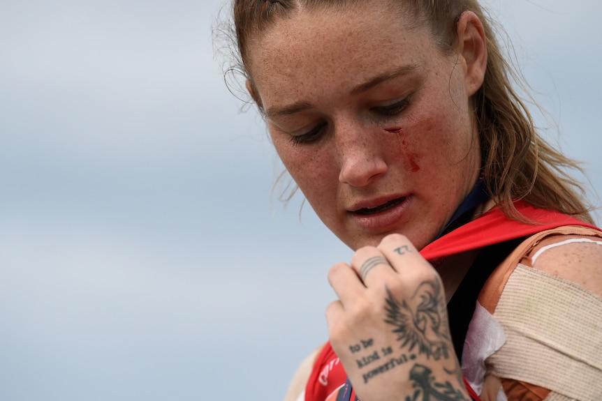 Tayla Harris looks down at her shoulder in a close up image of her after the AFLW grand final.