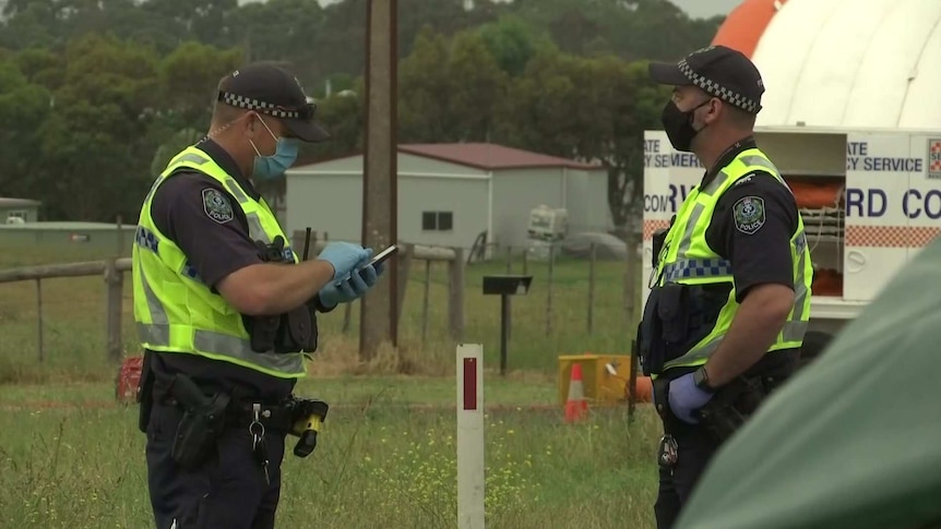 Two police officers at the scene of a multi-fatality crash near Mount Gambier