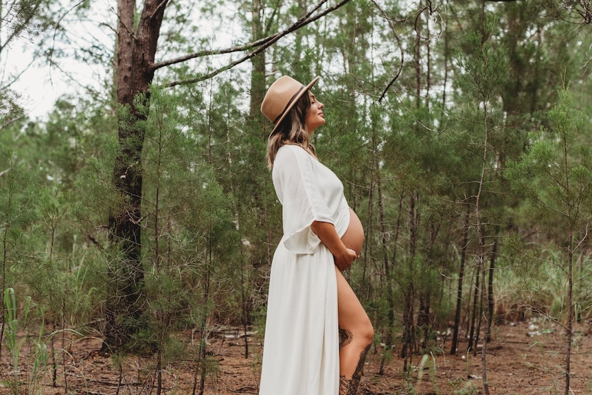 A pregnant woman photographed in Howard Springs pine forest.
