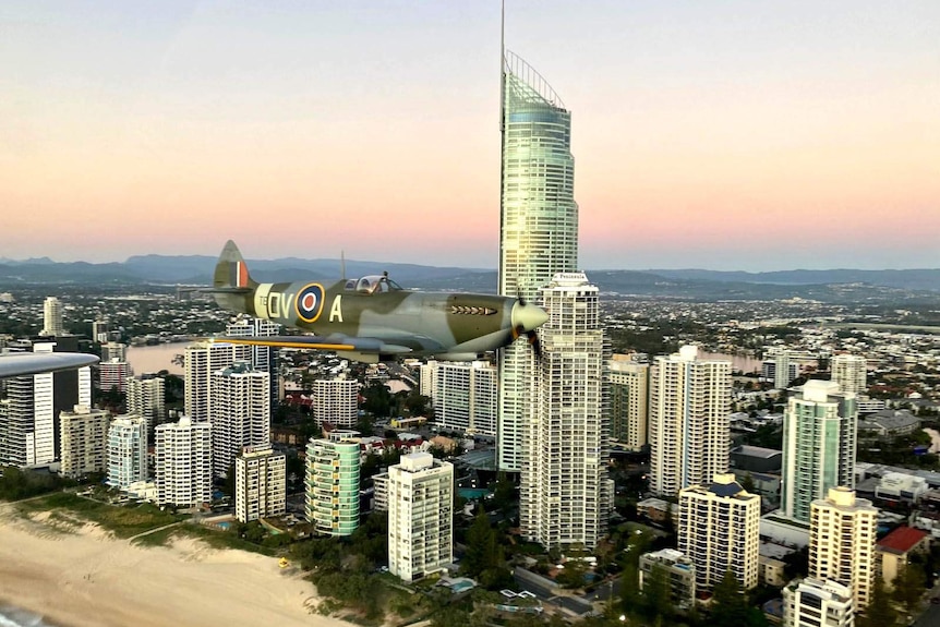 A World War II Spitfire flying above Surfers Paradise