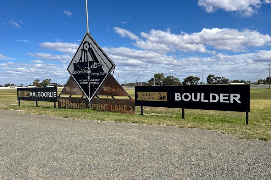 A sign saying Golden Mile Trotting Club at the edge of an oval in Kalgoorlie.