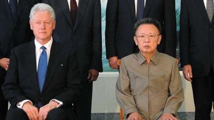 LtoR (seated) Former US president Bill Clinton and North Korea's leader Kim Jong-il pose for photo