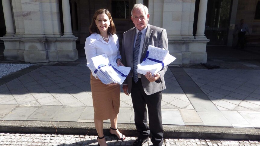 Deb Frecklington and  Kevin Reibel with a petition containing 20,162 signatures.
