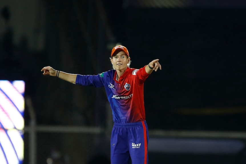 Meg Lannings points with both hands while standing in the field for Delhi Capitals in the Women's Premier League.