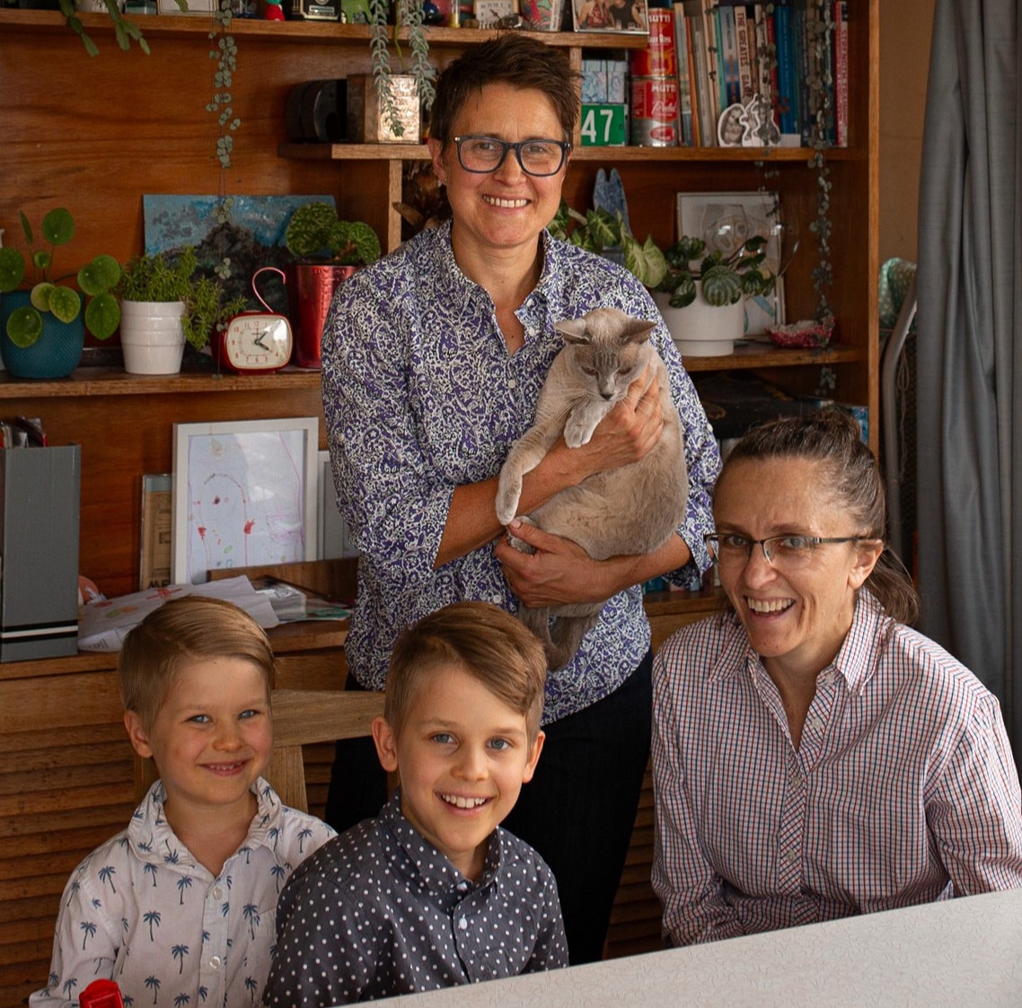 Two women with two young boys, family photo.