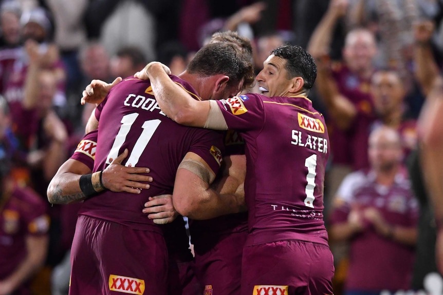 Billy Slater of the Maroons celebrates the try of Valentine Holmes during State of Origin game 3.