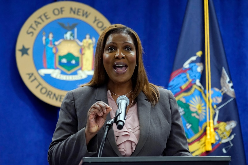 A woman stands while speaking at a news conference 