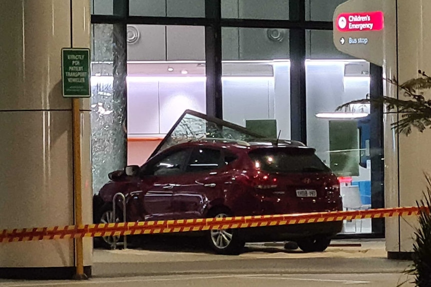 The wreckage of a red SUV after it crashed into a wall near the main entrance of Perth Children's Hospital.